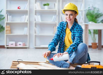 Female repairman carpenter cutting joining wooden planks doing r. Female repairman carpenter cutting joining wooden planks doing renovation