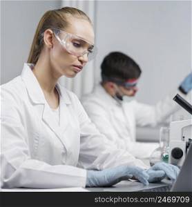 female researcher laboratory with safety glasses