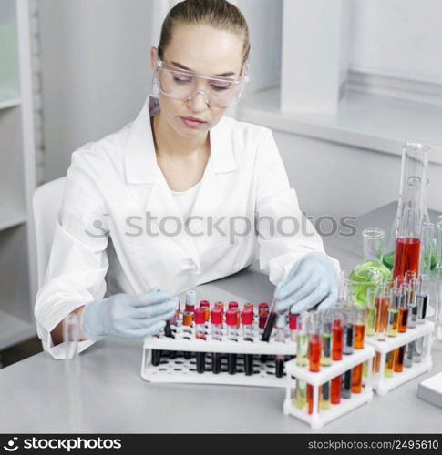 female researcher laboratory with test tubes gloves