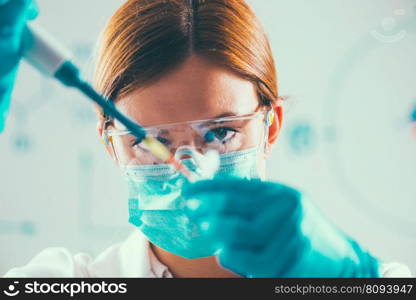 Female researcher using micro pipette