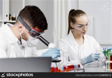 female researcher with gloves test tubes lab
