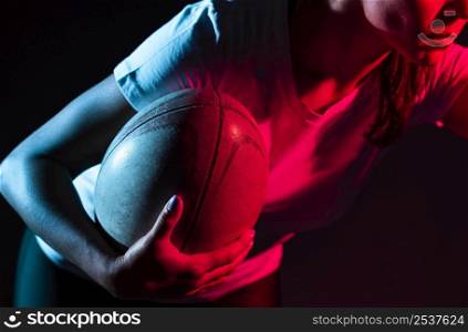 female rugby player holding ball