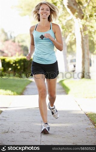 Female Runner Exercising On Suburban Street