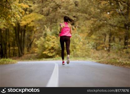 Female runner running during outdoor workout in countryside