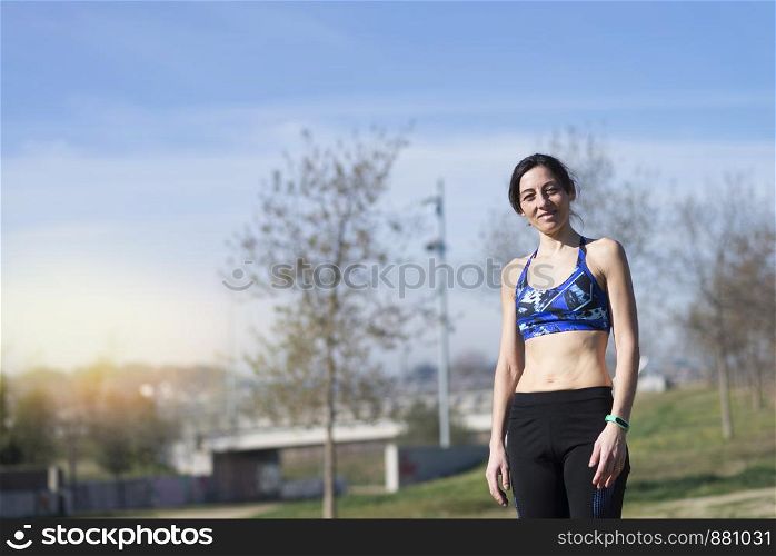 Female runner smiling at the park