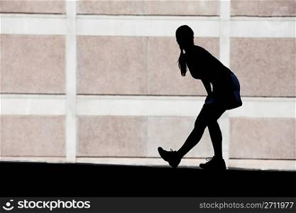 Female runner stretches in the morning.