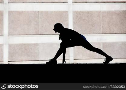 Female runner stretches in the morning.