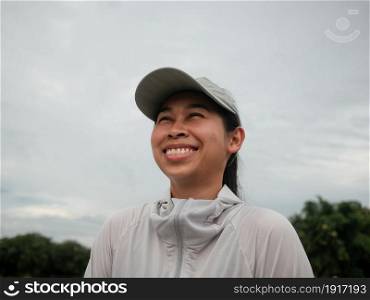 Female runners in a hat prepares for jogging outdoors. Athlete enjoying a morning of exercise. Healthy lifestyle concept.