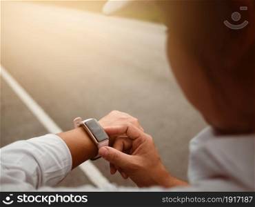 Female runners looking at smart watch heart rate monitor. Athlete running exercising outdoors and checking progress on smart watch. Healthy lifestyle concept.