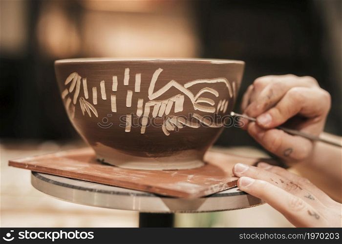 female s hand carving paint bowl. High resolution photo. female s hand carving paint bowl. High quality photo