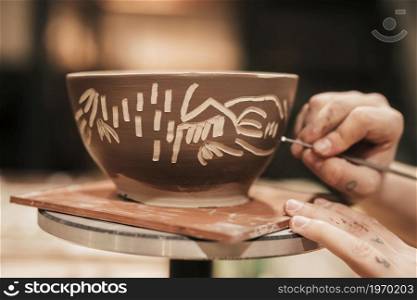 female s hand carving paint bowl. High resolution photo. female s hand carving paint bowl. High quality photo
