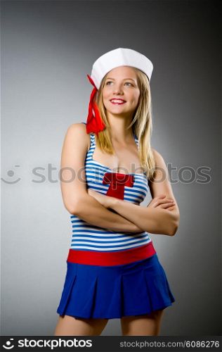 Female sailor against grey background
