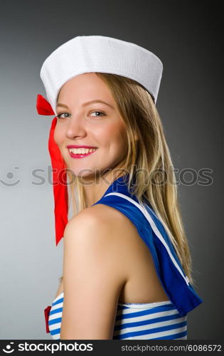 Female sailor against grey background