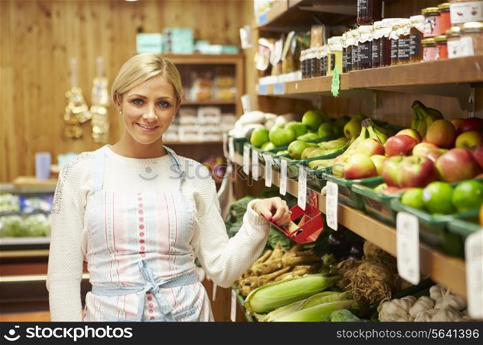 Female Sales Assistant At Vegetable Counter Of Farm Shop
