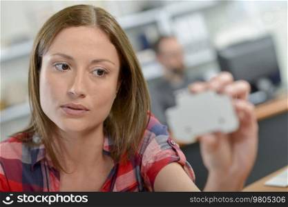 Female salesperson holding electrical product