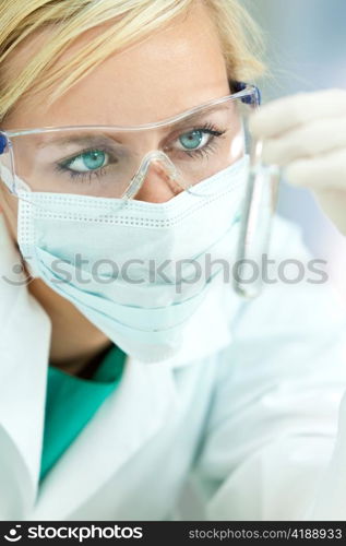 Female Scientist Doctor With Clear Solution Test Tube In Laboratory