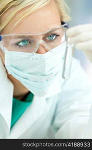 Female Scientist Doctor With Clear Solution Test Tube In Laboratory