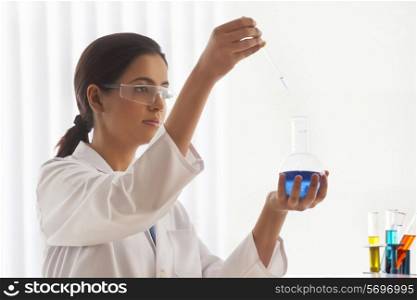 Female scientist experimenting in lab