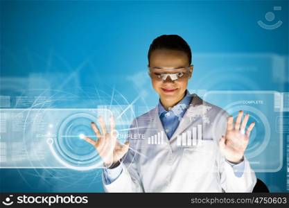 Female scientist. Image of young attractive woman scientist in protective eye wear