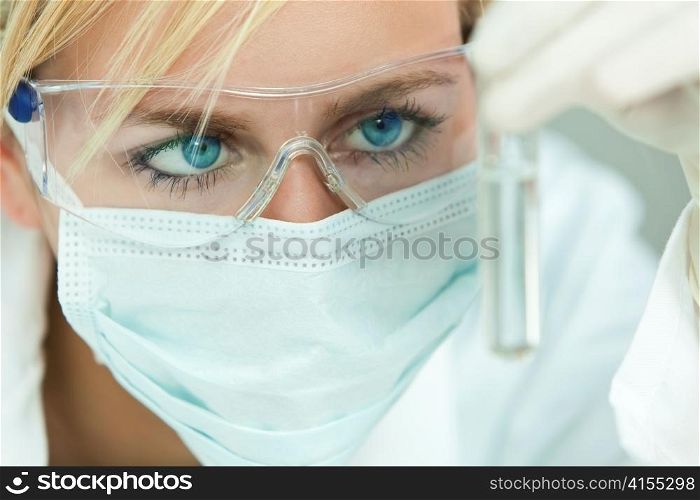 Female Scientist or Woman Doctor Analyzing Test Tube in Laboratory