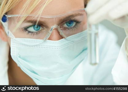 Female Scientist or Woman Doctor Analyzing Test Tube in Laboratory