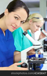 Female Scientist or Woman Researcher Using Microscope in Laboratory