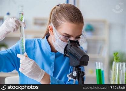 Female scientist researcher conducting an experiment in a labora. Female scientist researcher conducting an experiment in a laboratory