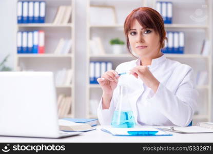 Female scientist researcher conducting an experiment in a labora. Female scientist researcher conducting an experiment in a laboratory