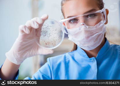 Female scientist researcher conducting an experiment in a labora. Female scientist researcher conducting an experiment in a laboratory