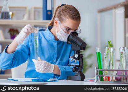 Female scientist researcher conducting an experiment in a labora. Female scientist researcher conducting an experiment in a laboratory