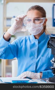 Female scientist researcher conducting an experiment in a labora. Female scientist researcher conducting an experiment in a laboratory