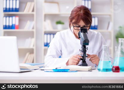 Female scientist researcher conducting an experiment in a labora. Female scientist researcher conducting an experiment in a laboratory