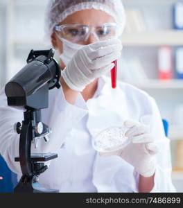 Female scientist researcher conducting an experiment in a laboratory. Female scientist researcher conducting an experiment in a labora