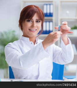 Female scientist researcher conducting an experiment in a laboratory. Female scientist researcher conducting an experiment in a labora