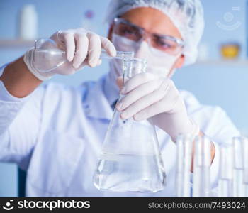 Female scientist researcher conducting an experiment in a laboratory. Female scientist researcher conducting an experiment in a labora