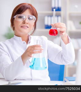 Female scientist researcher conducting an experiment in a laboratory. Female scientist researcher conducting an experiment in a labora