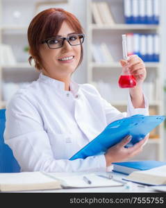 Female scientist researcher conducting an experiment in a laboratory. Female scientist researcher conducting an experiment in a labora