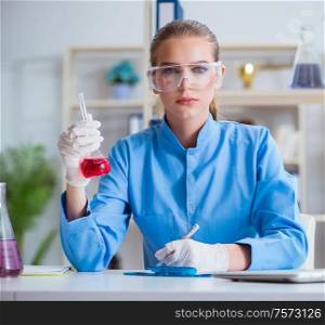 Female scientist researcher conducting an experiment in a laboratory. Female scientist researcher conducting an experiment in a labora