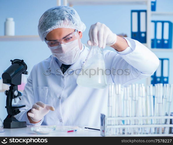 Female scientist researcher conducting an experiment in a laboratory. Female scientist researcher conducting an experiment in a labora