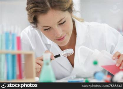 female scientist using magnifying glass
