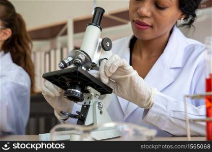 Female Scientist Using Microscope At Laboratory