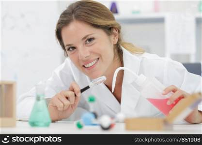 female scientist with a test tube working at the laboratory