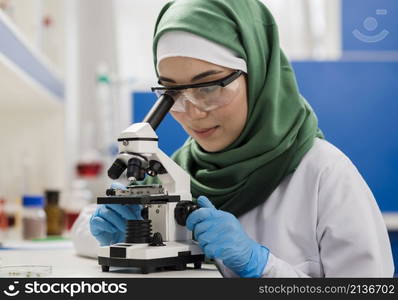 female scientist with hijab microscope laboratory