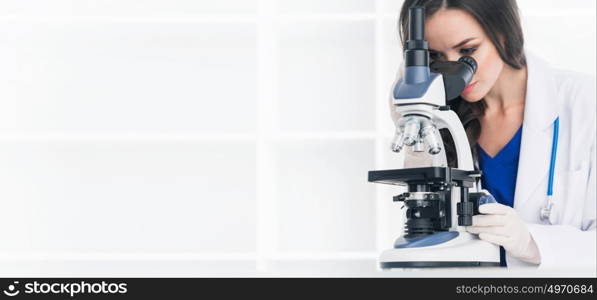 Female scientist with microscope. Female scientist working in a lab with microscope