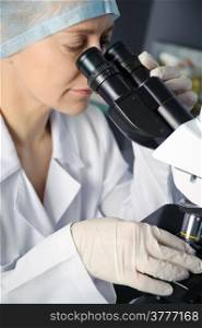 Female scientist working at the laboratory. Could be useful for medicine, hospital, research and development, clinical studies, forensics, science etc