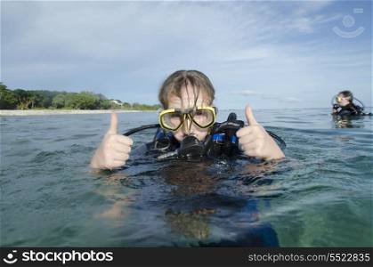 Female scuba diver showing thumbs up in the sea, Utila, Bay Islands, Honduras