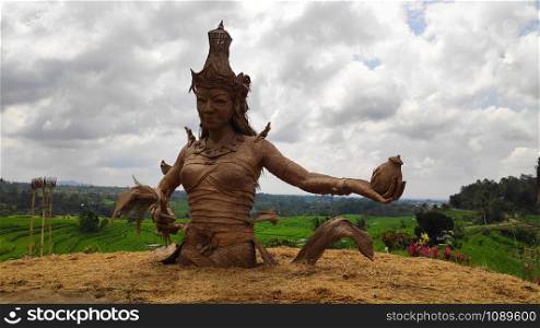 Female sculpture at rice fields of Jatiluwih in southeast Bali, Indonesia