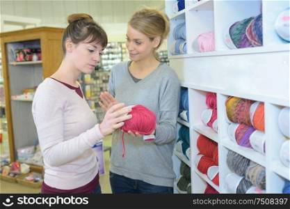 female seller and client looking at coils in store