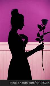 Female silhouette holding the flower