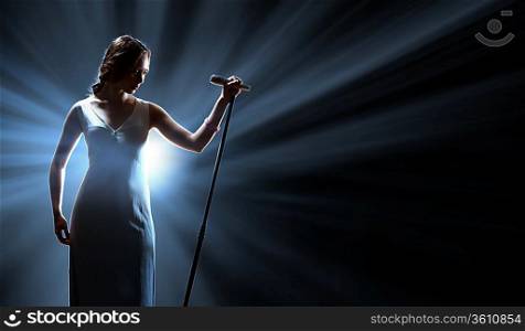 Female singer on the stage holding a microphone